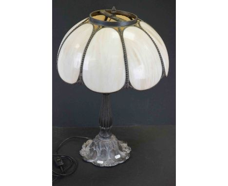 Tiffany style lamp with cast base decorated with lily pads. 