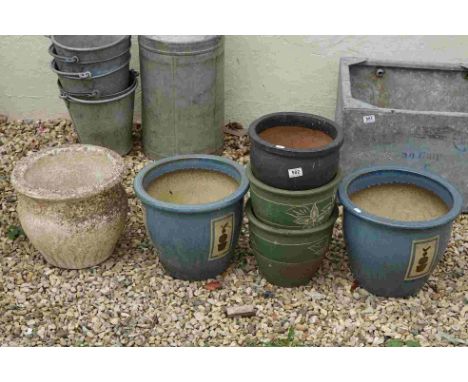 A collection of five decorative outdoor ceramic planters together with a stone example. 