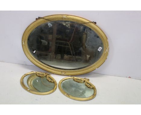 19th / Early 20th century Oval Gilt Framed Mirror, 89cms long together with a Pair of Small Gilt and Gesso Framed Oval Mirror