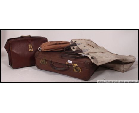 A collection of vintage leather suitcases and bags along with floor to ceiling gym ball