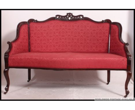 An Edwardian mahogany show wood framed 2 seat salon sofa settee raised on cabriole legs with rococo carved show wood frame wi