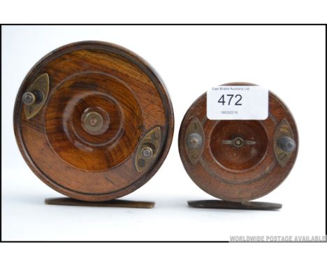 Two vintage wooden and brass decorated fishing reels, both stamped ' Made In England ' 