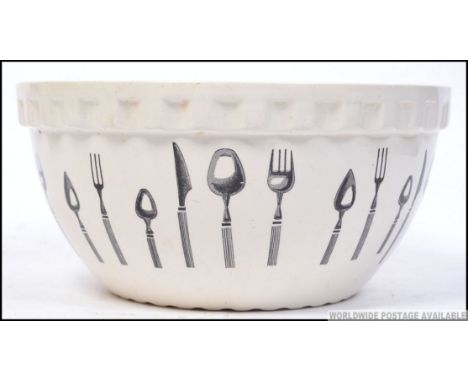 A large Pountney of Bristol ceramic mixing bowl with cutlery design to the outer. Stamped to the base ' Long line Kitchen War