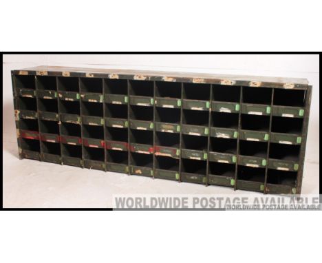 A vintage mid century industrial metal pigeon hole cabinet, consisting of several holes ex of Douglas Motorcycle factory Bris
