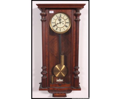 A 19th century Gustav Becker walnut large vienna regulator wall clock. The large case with swing pendulum and brass weights. 
