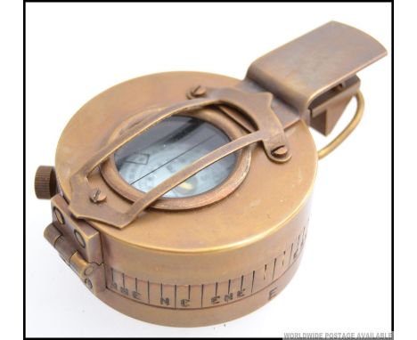 A brass military style compass.