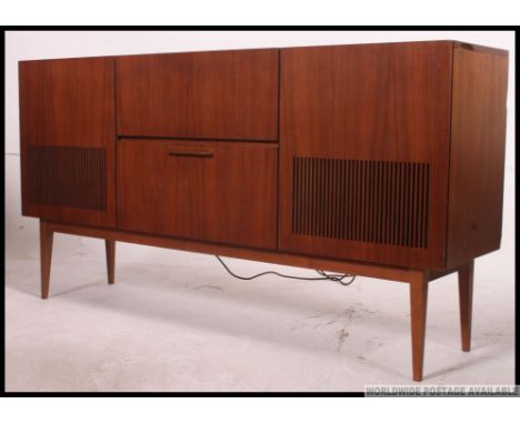 A 1970's retro teak wood stereogram with inset record deck, vented speaker front, hinged top and all on tapered legs. H78 x W