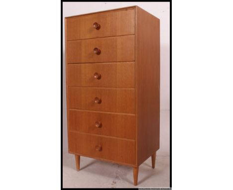 A retro 1970's Ernest Gomme for G-Plan light oak pedestal chest of drawers raised on tapered legs. Matching dressing table in