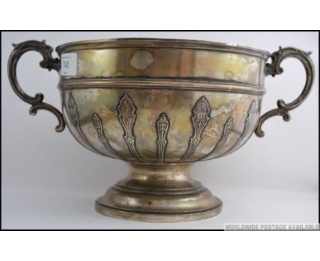 A silver hallmarked large twin handled rose bowl embellished with art nouveau reeding and scrolled twin handles. Hallmarks fo