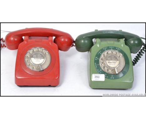 A pair of retro / vintage ring dial telephones. the first in red and the other in green