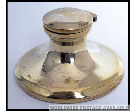 A hallmarked silver inkwell of circular form, with hinged lid. Hallmarked for Birmingham 1918 (makers mark slightly rubbed). 