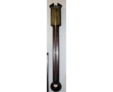 A Georgian mahogany stick barometer by Dolland of London. The baromoeter with brass register, the case with swan neck pedimen