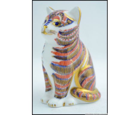 A Royal Crown Derby gold button figurine of a cat, with makers marks to base.