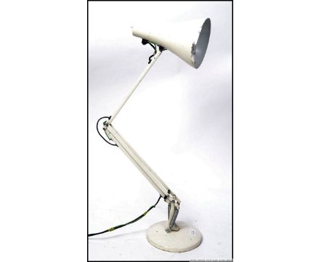 A vintage retro Herbert Terry Anglepoise lamp, having a circular base and stamped up with the Anglepoise