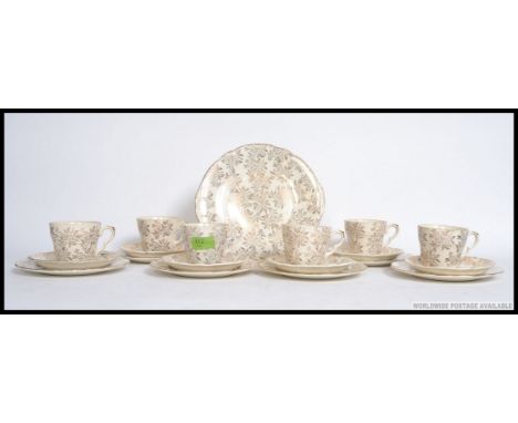 A vintage bone china tea service by Washington, being decorated with 22ct gold, consisting of six settings, stamped to base p