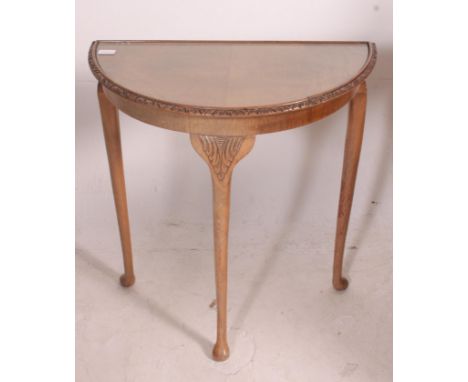 A 1950's walnut queen anne revival demi lune console hall table raised on cabriole legs and glass top together with a mahogan