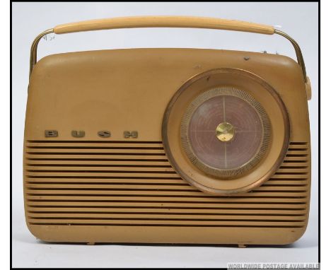 An original vintage 1050's Bush TR82B MW / LW radio, having a large circular dial and single speaker to the front, carry hand