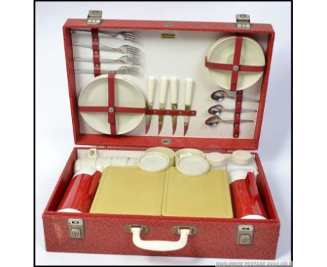 A four persons retro 1960's picnic hamper by Sirram, retaining all original contents to include both flasks, plates, cups cut