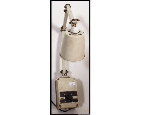 An early 20th century industrial factory wall mounted adjustable Memlite anglepoise light, with the original switch