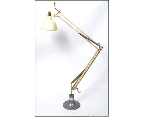 A Herbert Terry anglepoise lamp in cream with bell shade and raised on a later chrome base