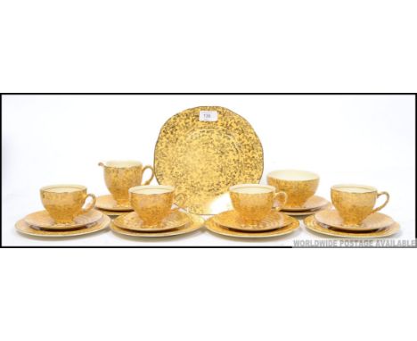 A 1930's Art Deco Empire ware part tea service. Yellow ground with gilt lustres, the set comprising cups, saucers, plates, su