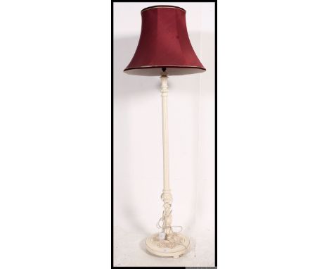 A 1930's painted mahogany shabby chic standard lamp on terraced bases with red shade atop. H175cm 