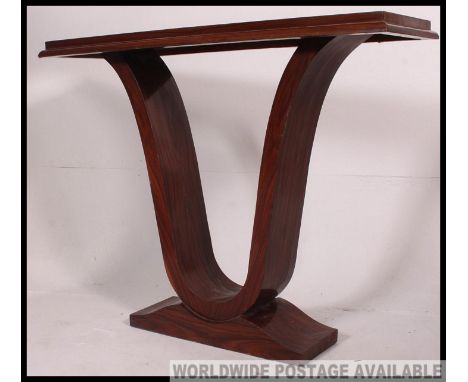 A 1930's Art Deco style console table raised on plinth base with scrolled supports and rectangular top above. H90 x W112 X D3