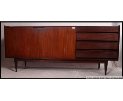 A 1970's retro / vintage  teak sideboard believed to be by Richard heritage for Archie Shine raised on tapered legs with a se