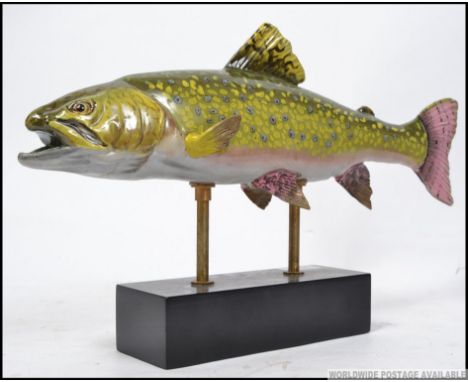 A highly decorative 20th century ceramic trout fish on a elongated plinth base. 