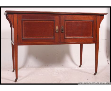 An Edwardian mahogany washstand cabinet being raised on squared legs with a double door cupboard. Matching bow front double b