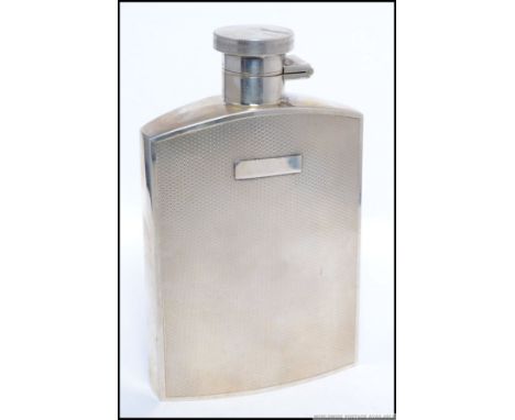 A good quality 13.5cm tall machine turned gentlemans hip flask with screw release hinged top, with Birmingham Assay dated for