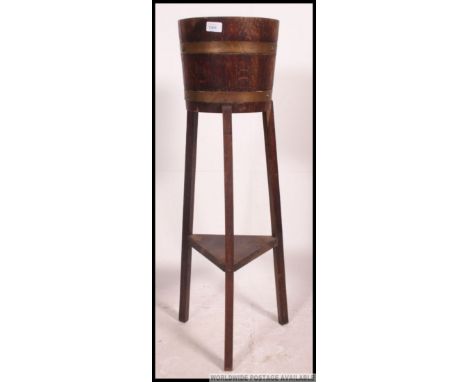 A Lister of Dursley style coopered barrell planter on raised legs with copper banding to the barrell. H91cm