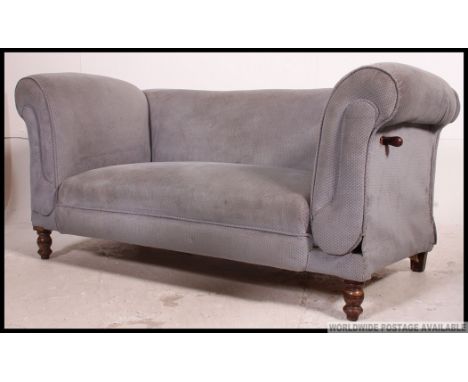 An Edwardian drop end chesterfield sofa settee raised on bun legs with castors having blue velour seat with drop end arm to o