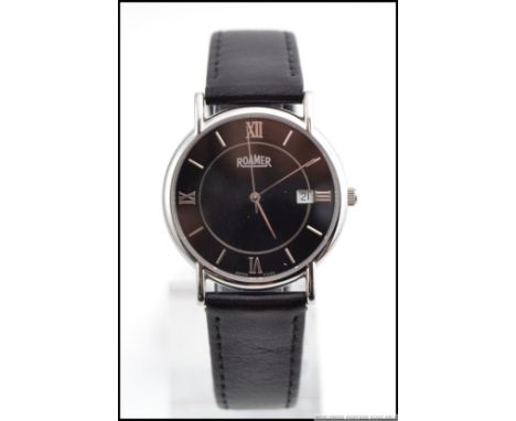 A gentlemans Roamer  black faced swiss vintage gentlemans wristwatch. The face with roman qtr's and batons with faceted hands