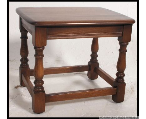 An Ercol Golden Dawn beech and elm wood side - lamp table. Raised on turned legs united by stretcher Matching 6 chairs , side