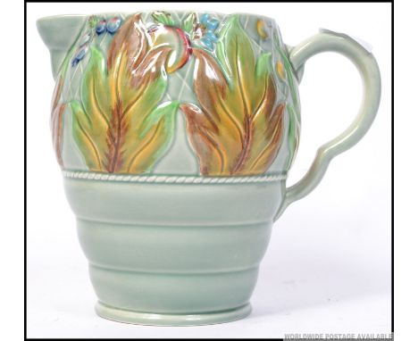 A Clarice Cliff large water jug with moulded leaf and berry foliate to body. Stamped to base 41a. H19cm 