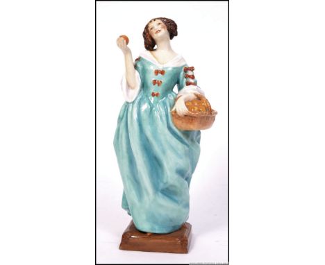 A Royal Worcester ' Sweet Nell of Old Drury ' blue dress, model No. 3006  by Anne Acheson with puce back stamp's. H24cm 