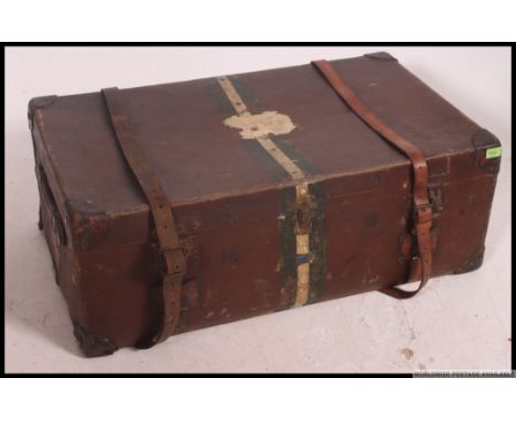 An early 20th century Harrods canvas, leather and wooden bound steamer trunk. The case with leather handles and corners, slat