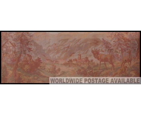 A large 20th century framed tapestry panel set within a gilt frame. The continental tapestry with stags, castles and lake sce