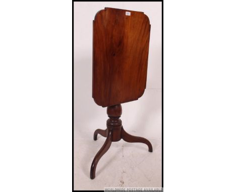 A 19th century Georgian mahogany tilt top tripod wine  table. The base on splayed legs with turned column and shaped square t