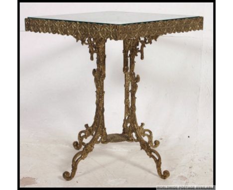 A 20th century vintage gilt cast metal coffee table base, having a fret pierced gallery raised on pedestal legs having a drop