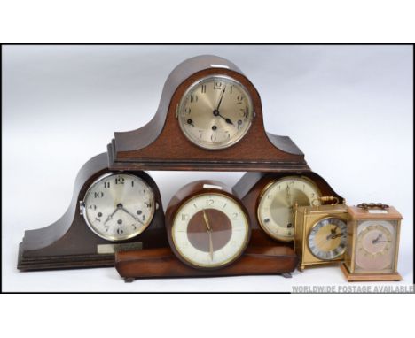 A collection of mid century clocks to include Bentima, Smiths walnut, oak 40's mantel clocks along with a Metamec carriage cl