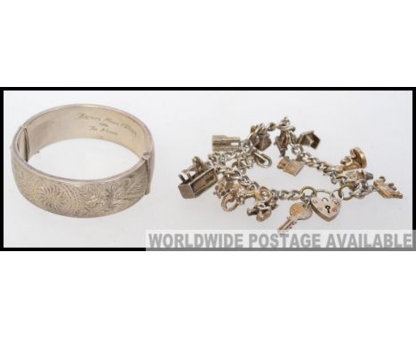 A hallmarked silver ladies bangle, along with a charm bracelet featuring some white metal / silver charms (either unmarked, o