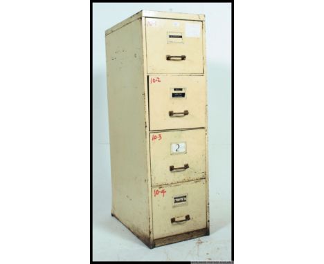 A set of four drawer vintage industrial slim metal filing cabinet, painted white brass handles above notion slides, taken fro