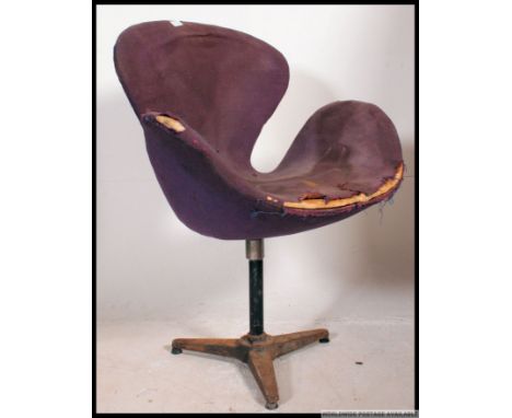 An original Arne Jacobsen for Fritz Hansen Swan chair. The original seat frame with original purple fabric being raised on a 