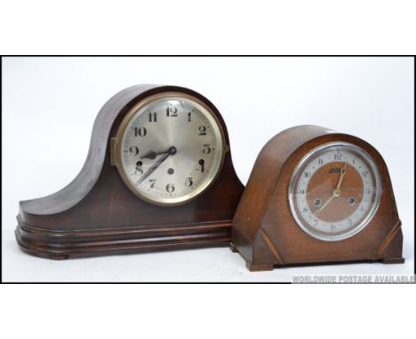An early 20th century mahogany napoleons hat mantel clock, along with an Art Deco oak mantel clock, smaller.