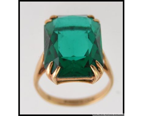 A vintage   ladies 9ct gold and blue / green tourmaline stone set dress ring. The large square cut stone on claw mount with h