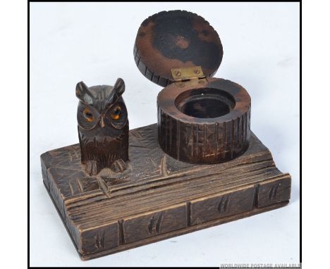 A 20th century Black forest desk tidy - inkwell with pen tray, trunk well and owl with glass eyes. W13cm 