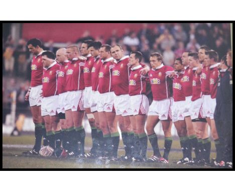 A framed and glazed British Lions tour photo along with a signed Johnny Wilkinson and Jonah Lomu