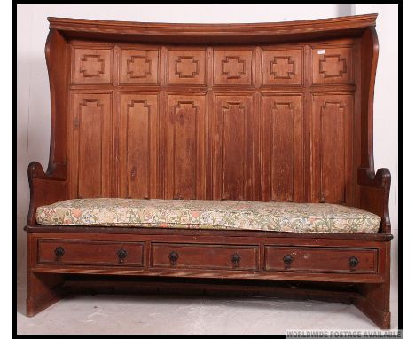 A fabulous 19th century large country pine inverse bow fronted pew / monks bench. The rear with fielded panels and hood over 